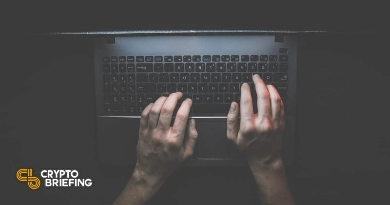 Person typing on a laptop keyboard in a dimly lit environment, illustrating security vulnerability and privacy concerns.