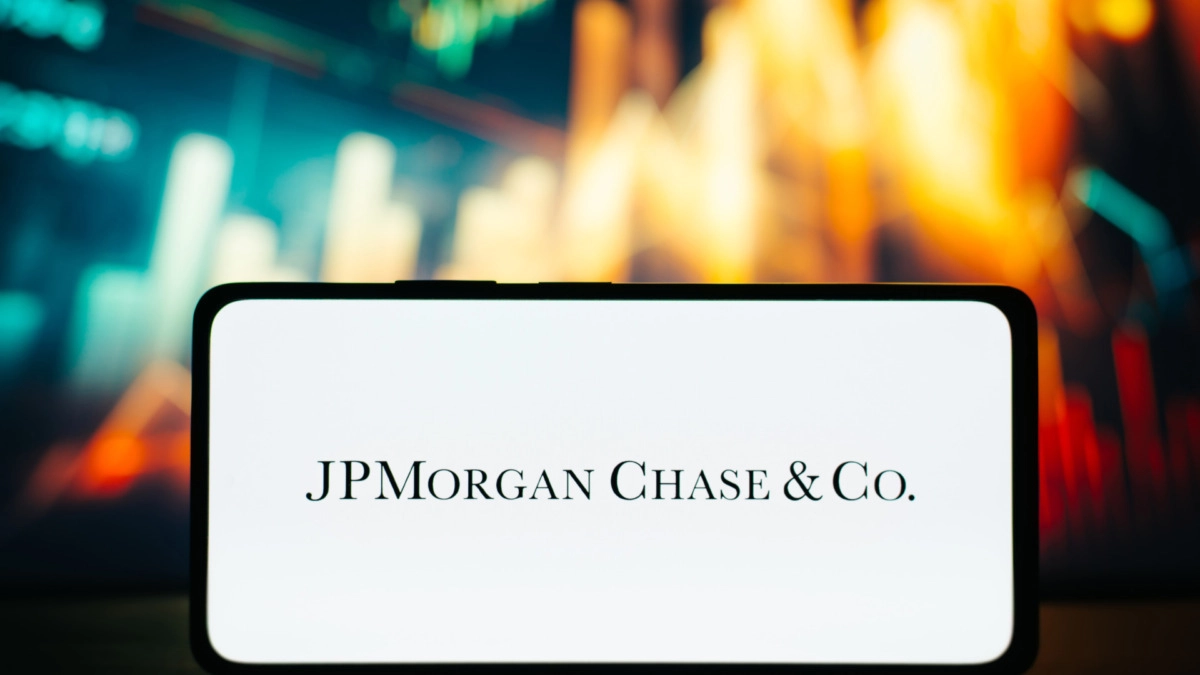 JPMorgan Chase american multinational financial conglomerate logo on smartphone against background of stock exchange chart. Finance and investment business concept. Astana, Kazakhstan 20.02.2023.