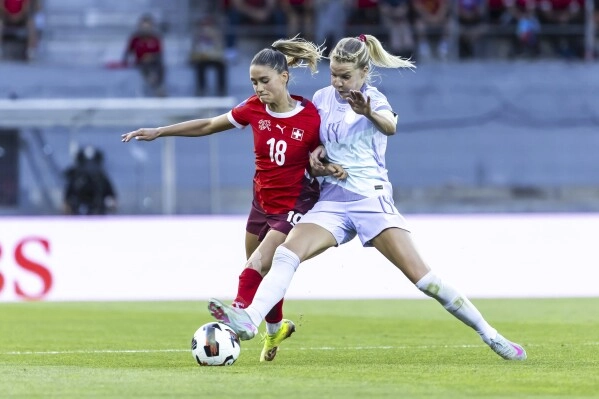 Switzerland's Viola Calligaris, left, and Norway's Ada Hegerberg, right, challenge for the ball during the Women's Nations League, group A2, soccer match between Switzerland and Norway in Sion, Switzerland, Tuesday, June 3, 2025. (Salvatore Di Nolfi/Keystone via AP)