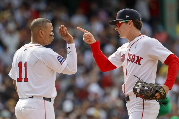 Boston Red Sox's Roman Anthony, right, celebrates with designated hitter Rafael Devers (11) after defeating the New York Yankees in a baseball game, Sunday, June 15, 2025, in Boston. (AP Photo/Greg M. Cooper)