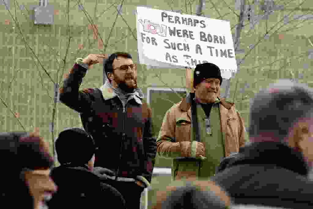 Take Back Alberta's David Parker (top left) speaks to supporters outside Elections Alberta's offices in Edmonton, Friday March 22, 2024.