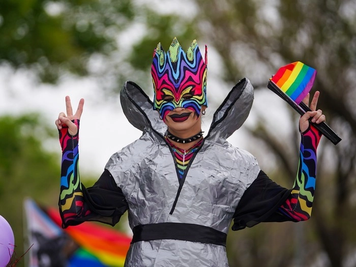 A person gestures during the Queen City Pride Parade