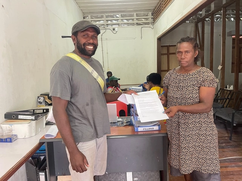 Community members in Papua New Guinea holding a letter about deep-sea mining.