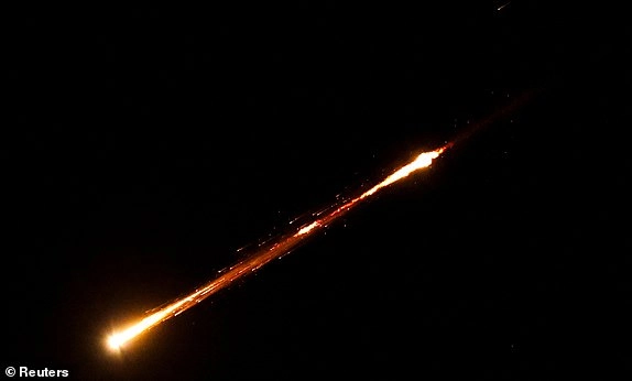 A missile launched from Iran towards Israel is seen from Ramallah, Israeli-occupied West Bank, June 18, 2025. REUTERS/Mohamad Torokman