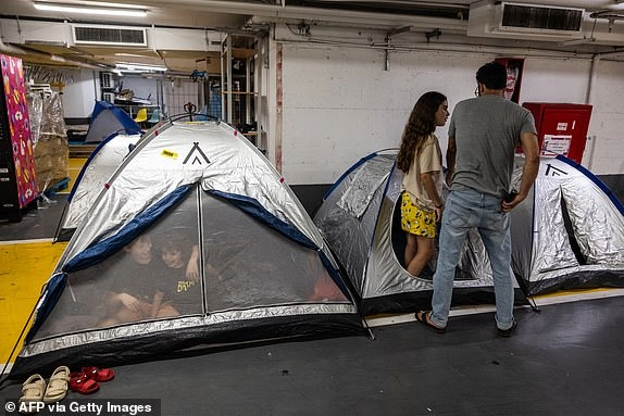 People take shelter for the night in tents at an underground parking lot in central Tel Aviv on June 17, 2025 amidst fears of an Iranian missile attack. (Photo by Menahem Kahana / AFP) (Photo by MENAHEM KAHANA/AFP via Getty Images)