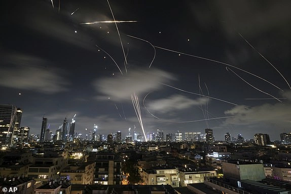 The Israeli Iron Dome air defense system fires to intercept missiles during an Iranian attack over Tel Aviv, Israel, early Wednesday, June 18, 2025. (AP Photo/Leo Correa)