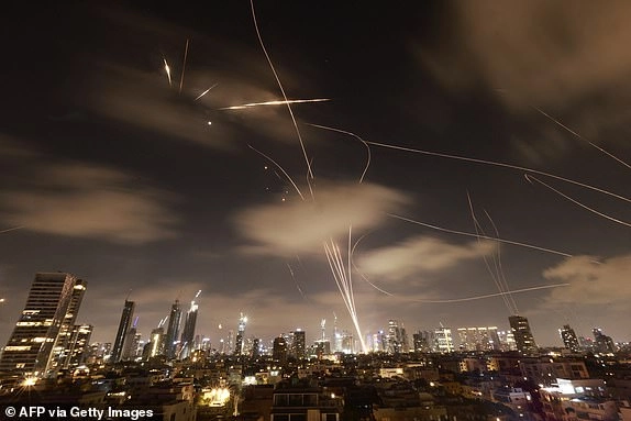 Israeli air defence systems are activated to intercept Iranian missiles over the Israeli city of Tel Aviv early on June 18, 2025. Israel and Iran exchanged fire again on June 17, the fifth day of strikes in their most intense confrontation in history, fuelling fears of a drawn-out conflict that could engulf the Middle East. (Photo by Menahem Kahana / AFP) (Photo by MENAHEM KAHANA/AFP via Getty Images)