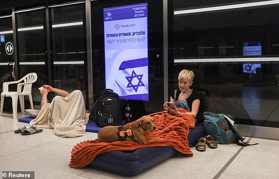People rest inside an underground train station used as a shelter amid rounds of missile attacks from Iran to Israel in recent days, in Ramat Gan, Israel June 17, 2025. REUTERS/Ronen Zvulun
