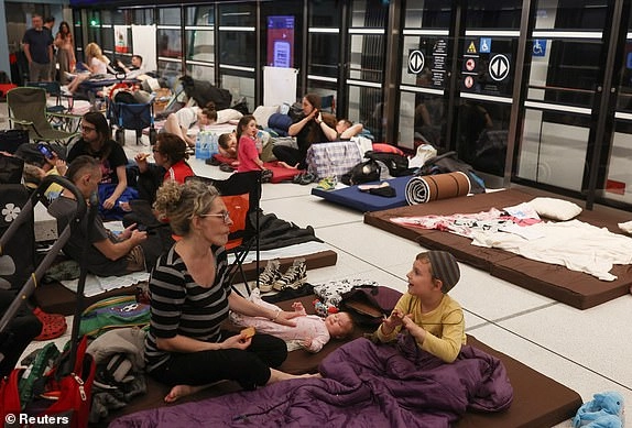 People rest inside an underground train station used as a shelter amid rounds of missile attacks from Iran to Israel in recent days, in Ramat Gan, Israel June 17, 2025. REUTERS/Ronen Zvulun