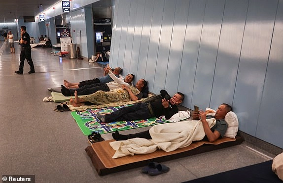 People rest inside an underground train station used as a shelter amid rounds of missile attacks from Iran to Israel in recent days, in Ramat Gan, Israel June 17, 2025. REUTERS/Ronen Zvulun