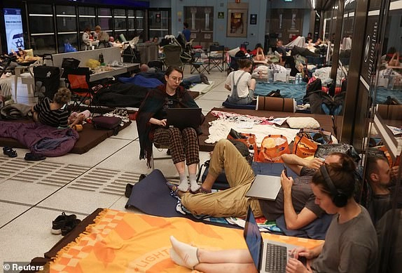 People rest inside an underground train station used as a shelter amid rounds of missile attacks from Iran to Israel in recent days, in Ramat Gan, Israel June 17, 2025. REUTERS/Ronen Zvulun