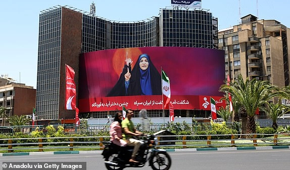 TEHRAN, IRAN - JUNE 17: A view of banner of Iranian State TV presenter Sahar Emami, who was targeted live on air during the Israeli attack, in Veliasr Square in Tehran, Iran on June 17, 2025. Emami was declared a 'hero' in the country. (Photo by Fatemeh Bahrami/Anadolu via Getty Images)