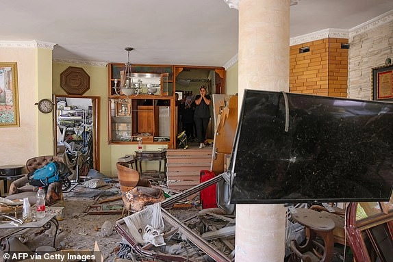 Women react as they check their destroyed house in the northern Arab-Israeli city of Tamra, on June 17, 2025, after its was struck with a missile fired from Iran on the weekend. An Iranian missile killed four people in the city of Tamra on June 14: Manar al-Qassem Abu al-Hija Khatib (39), her two daughters Hala (13) and Shada (20), and their relative Manar Diab Khatib (41). Dozens more were wounded. (Photo by AHMAD GHARABLI / AFP) (Photo by AHMAD GHARABLI/AFP via Getty Images)