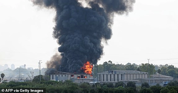 Smoke billows from a fire in a building in Herzliya near Tel Aviv following a fresh barrage of Iranian rockets on June 17, 2025. Israel's military said air raid sirens sounded in several areas of the country on June 17 after identifying missiles launched from Iran, as AFP journalists reported booms over Tel Aviv and Jerusalem. (Photo by Jack GUEZ / AFP) (Photo by JACK GUEZ/AFP via Getty Images)