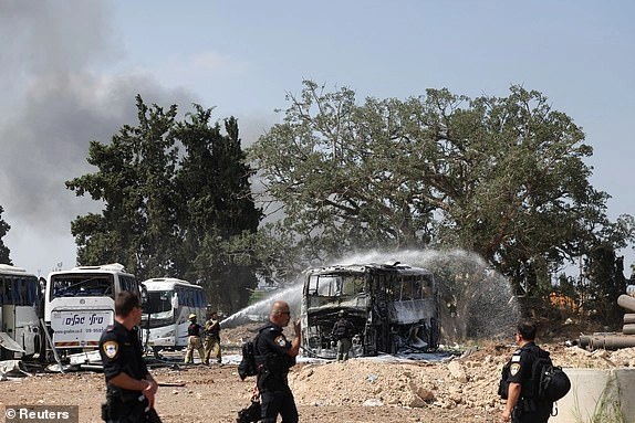 Emergency personnel work at the site of a missile attack from Iran, in Herzliya, Israel, June 17, 2025. REUTERS/Ronen Zvulun