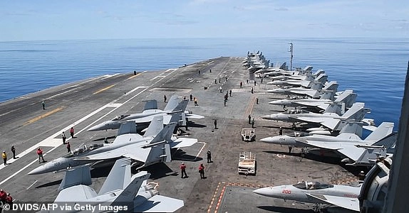 This handout grab taken from footage released by the US Defence Visual Information Distribution Service (DVIDS) on June 11, 2025 shows the aircraft carrier USS Nimitz (CVN 68) conducting flight operations in the South China Sea, on May 28, 2025. The aircraft carrier USS Nimitz was leaving Southeast Asia on June 16, 2025 after cancelling plans to dock in Vietnam, amid reports it is headed to the Middle East to boost the US presence as Israel and Iran do battle. (Photo by Edward Jacome / DVIDS / AFP) / RESTRICTED TO EDITORIAL USE - MANDATORY CREDIT 