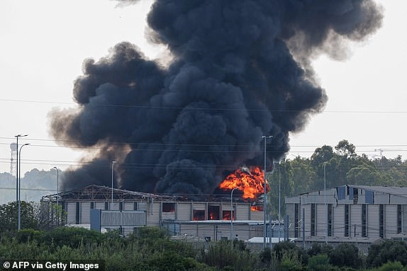 Smoke billows from a fire in a building in Herzliya near Tel Aviv following a fresh barrage of Iranian rockets on June 17, 2025. Israel's military said air raid sirens sounded in several areas of the country on June 17 after identifying missiles launched from Iran, as AFP journalists reported booms over Tel Aviv and Jerusalem. (Photo by Jack GUEZ / AFP) (Photo by JACK GUEZ/AFP via Getty Images)