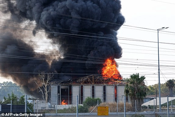 Smoke billows from a fire in a building in Herzliya near Tel Aviv following a fresh barrage of Iranian rockets on June 17, 2025. Israel's military said air raid sirens sounded in several areas of the country on June 17 after identifying missiles launched from Iran, as AFP journalists reported booms over Tel Aviv and Jerusalem. (Photo by Jack GUEZ / AFP) (Photo by JACK GUEZ/AFP via Getty Images)
