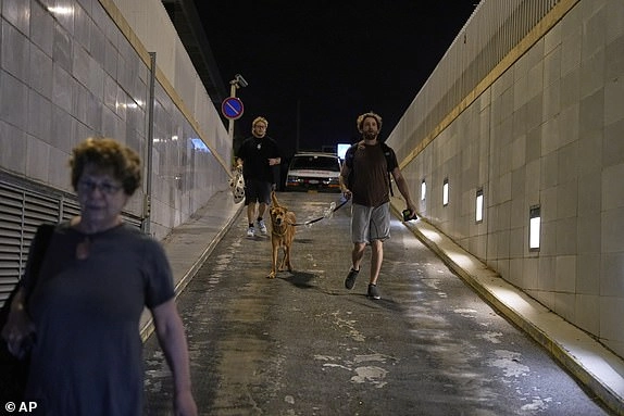 Israelis rush to take shelter in a parking garage during a missile alert from Iran, in Tel Aviv, Israel, early Tuesday, June 17, 2025. (AP Photo/Baz Ratner)