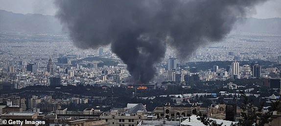 TEHRAN, IRAN - JUNE 16: Smoke rises after a reported Israeli strike on a building used by Islamic Republic of Iran News Network, part of Iran's state TV broadcaster, on June 16, 2025 in Tehran, Iran. Over recent days, Iran has been hit by a series of Israeli airstrikes targeting military and nuclear sites, as well as top military officials, prompting Iran to launch a counterattack. (Photo by Stringer/Getty Images)