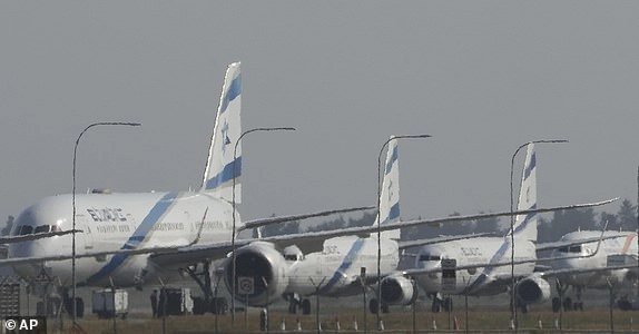 A row of aircrafts belonging to Israeli airlines El Al sit parked along the apron of Cyprus' main airport in Larnaca, Saturday, June 14, 2025. (AP Photo/Petros Karadjias)