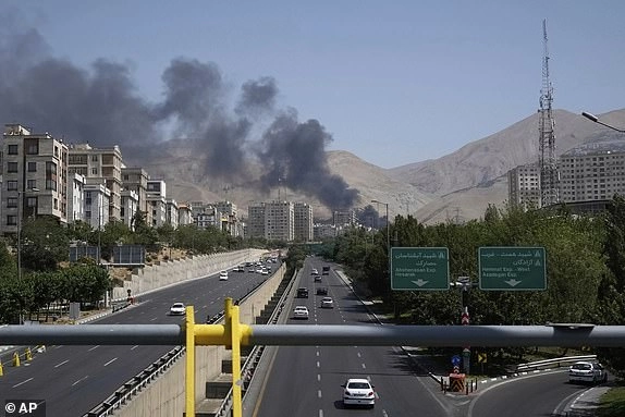 Smoke rises from an oil storage facility after it appeared to have been struck by an Israeli strike on Saturday, in Tehran, Iran, Monday, June 16, 2025. (AP Photo/Vahid Salemi)