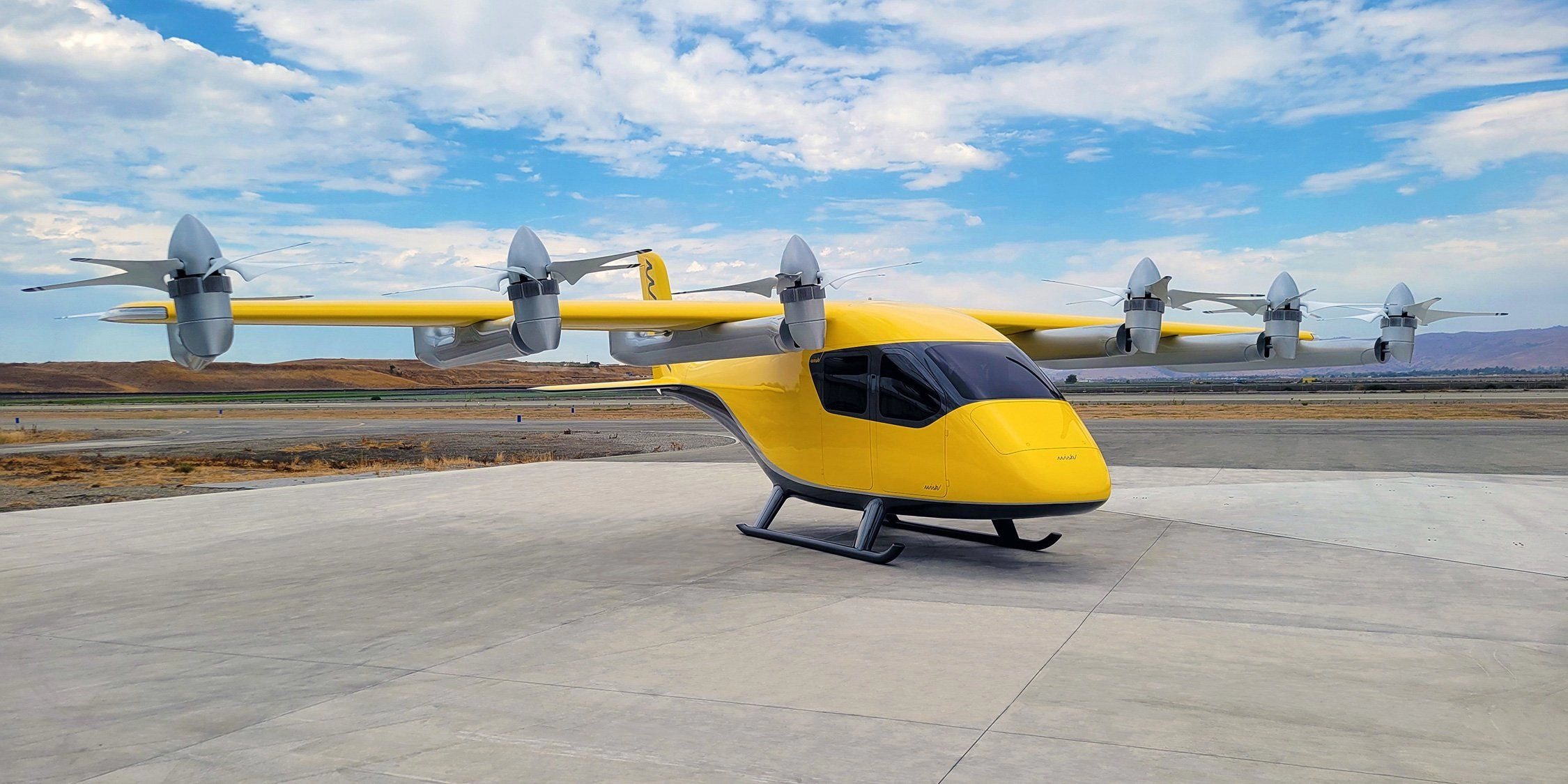 a futuristic, bright yellow aircraft sits on a large concrete pad with a blue sky in the background. 