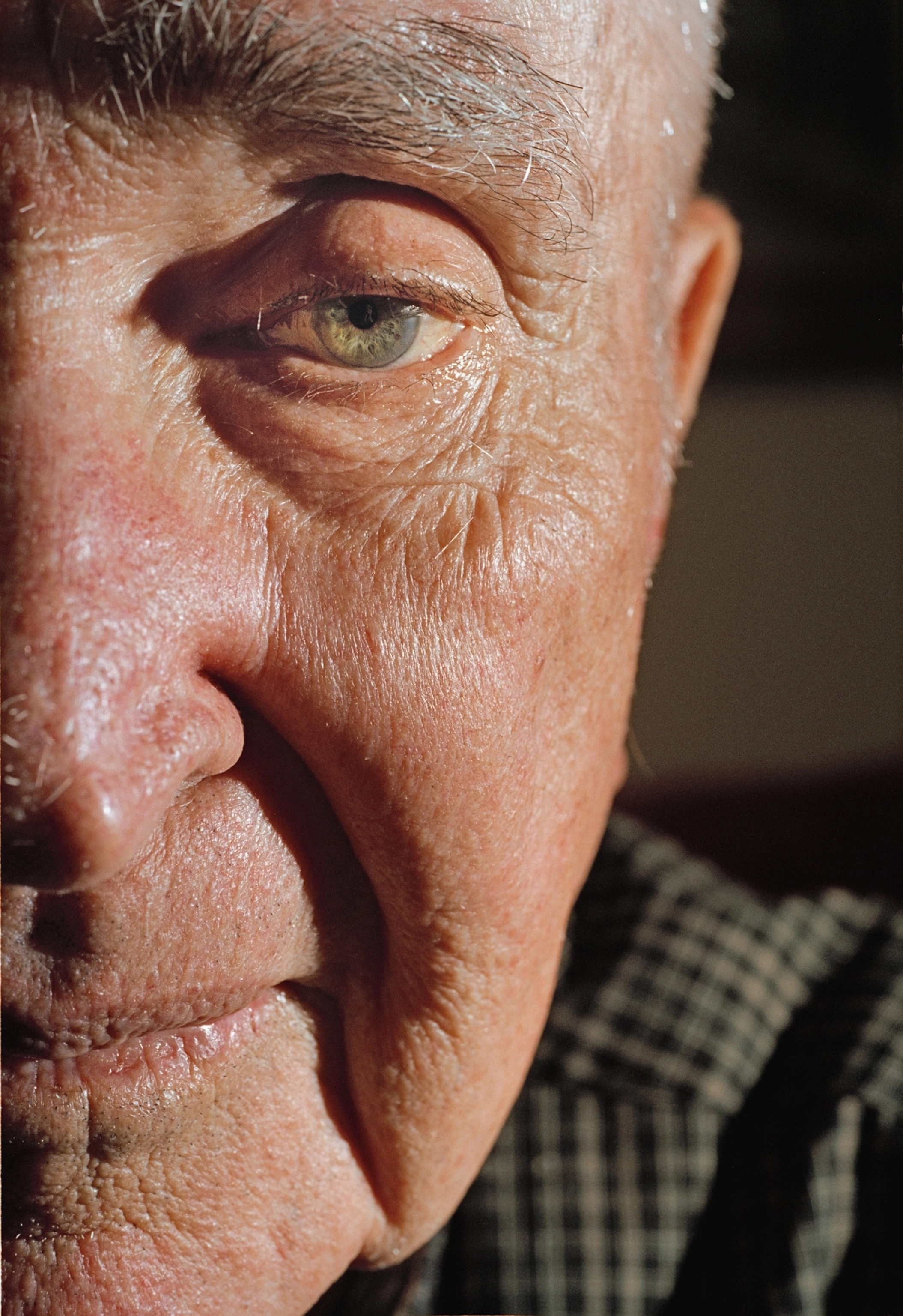 A close up shot of an older man's face. Only half of his face is in frame.