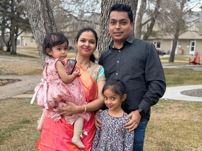 Piyushkumar Patel stands with his wife Ruchita, and daughters Kiya (right) and Pranshi (left).