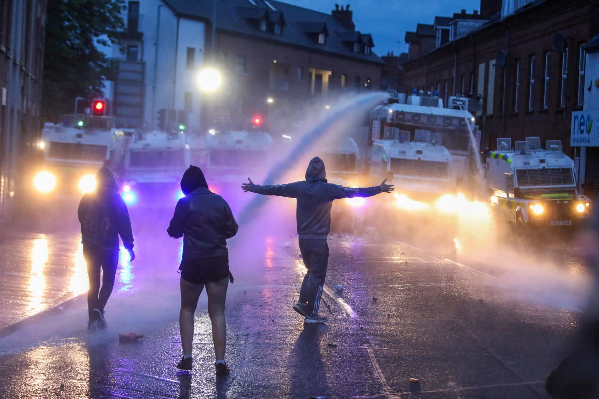 Northern Ireland riot police use a water cannon to disperse anti-immigration protesters in Ballymena earlier this month