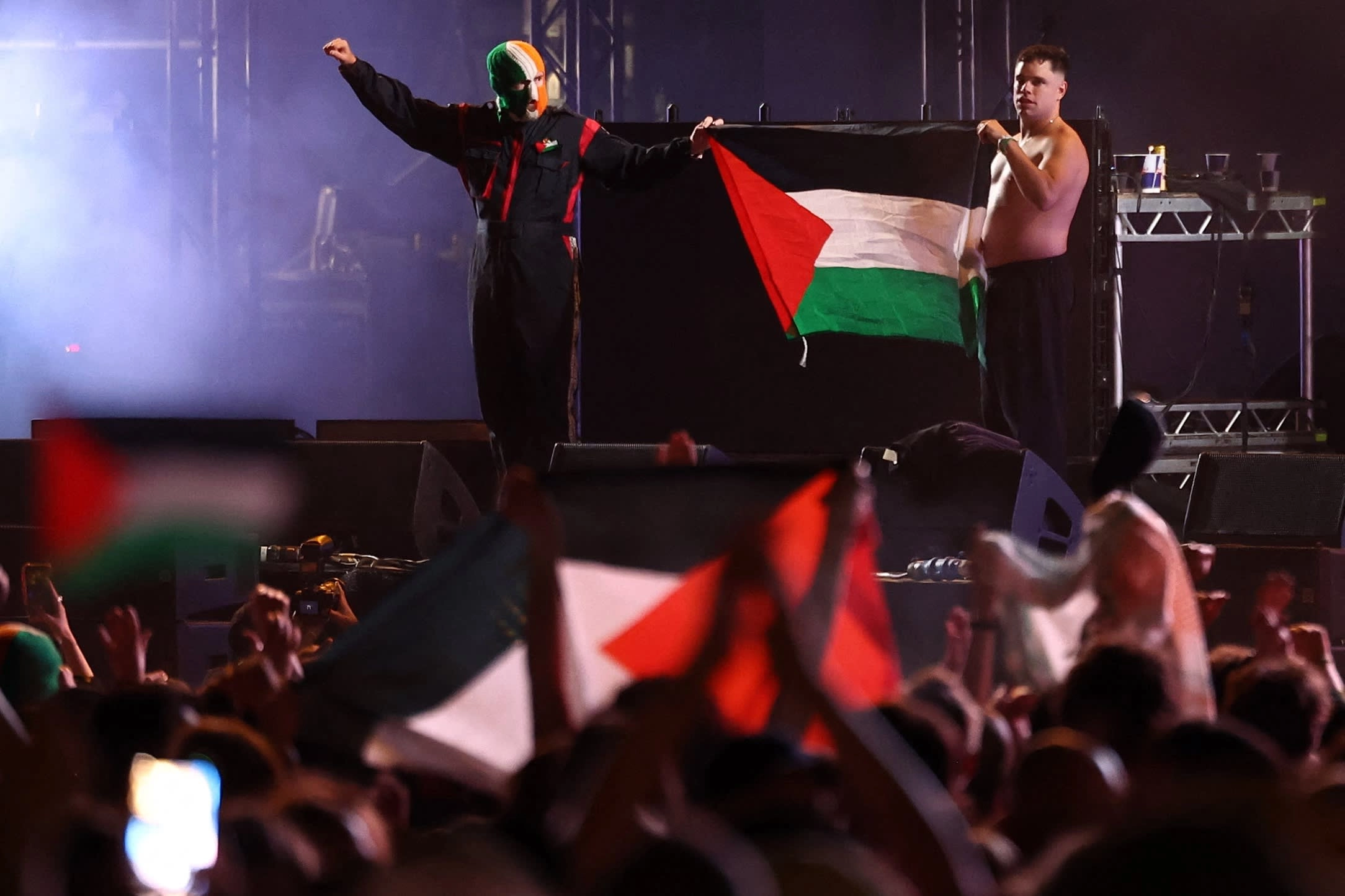 (L-R) JJ �Dochartaigh (DJ Pr�va�) and Naoise � Caireall�in (M�gla� Bap) of Kneecap, display the Palestinian flag after performing at a festival in London last month