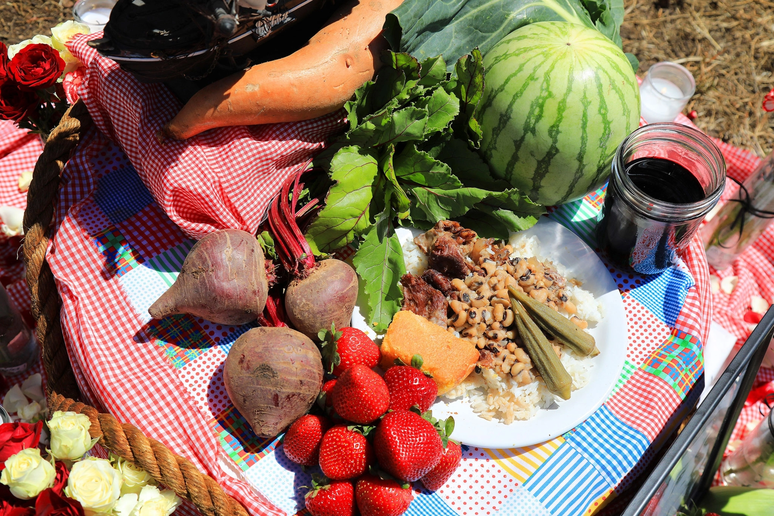 A collection of different foods, wtermelon, strawberries, beats and tea.