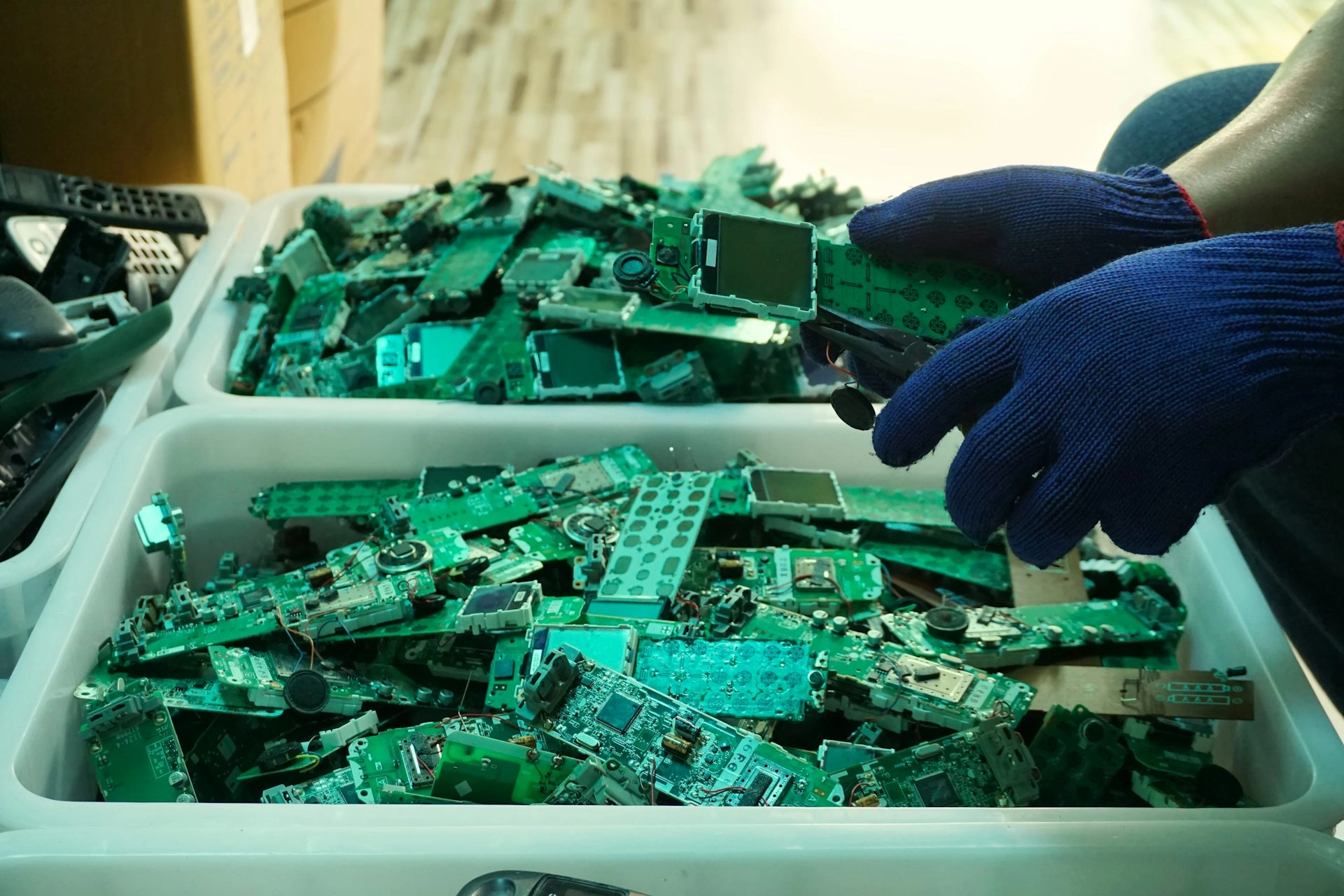 A bucket full of telephone circuit board parts.