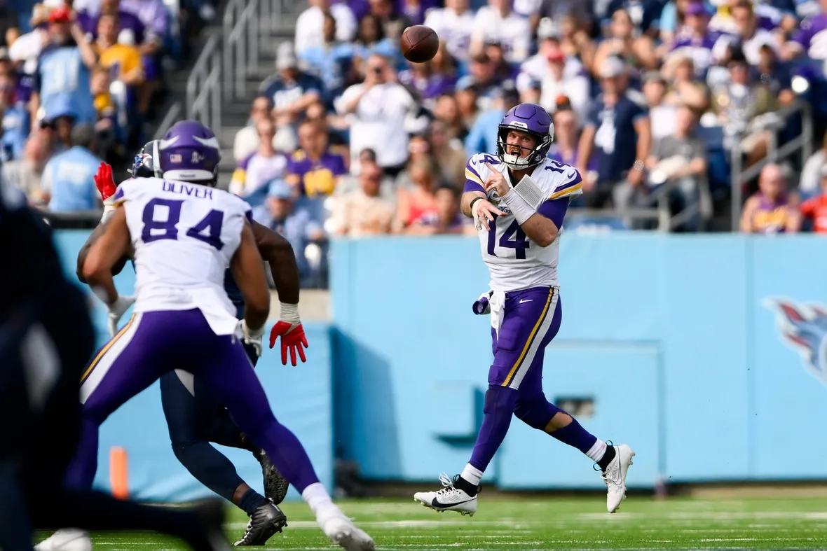 Sam Darnold rolls out for a pass vs. Titans