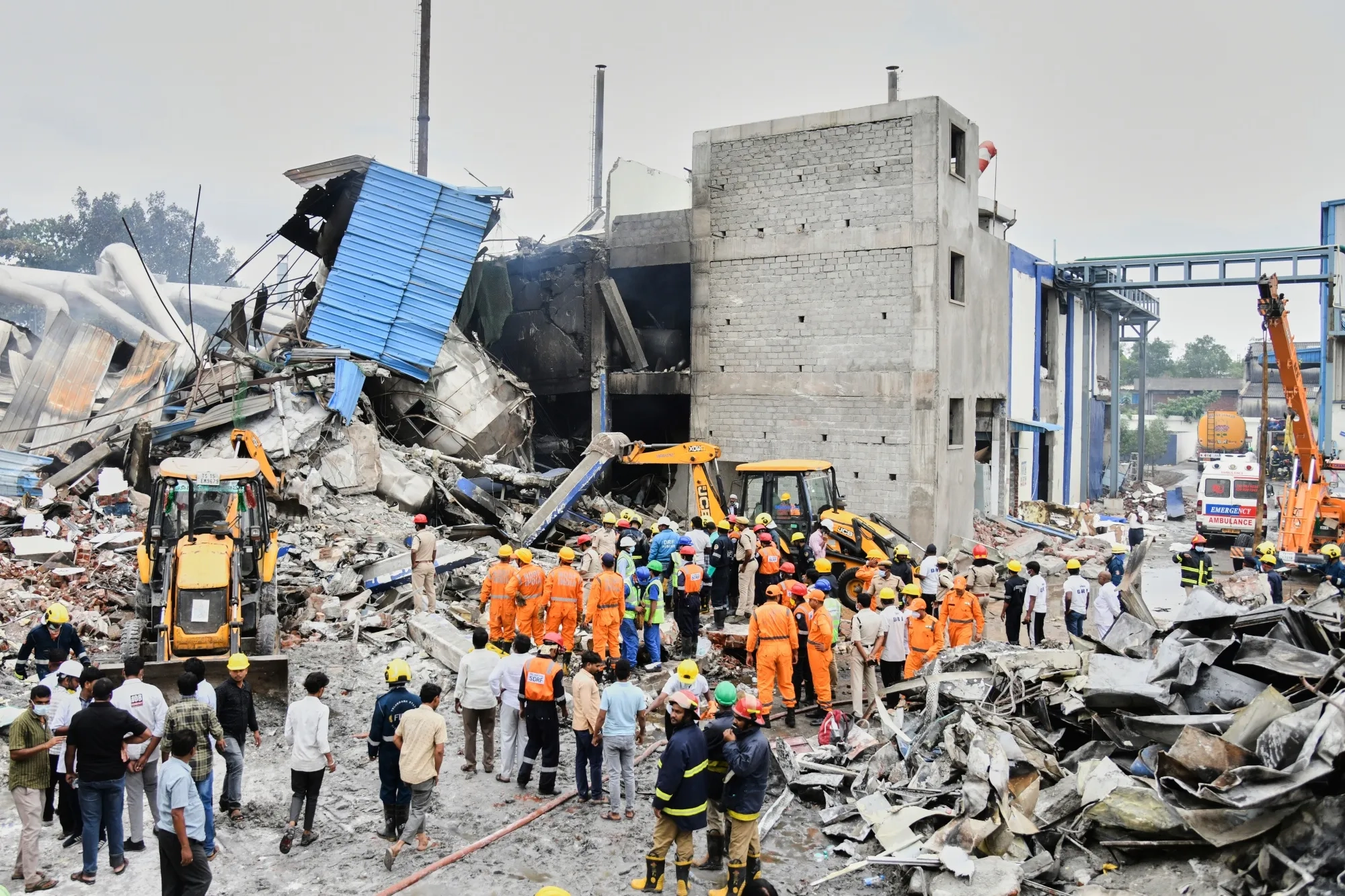 Rescue workers at the site of a fire and explosion in Sangareddy, India, on June 30.