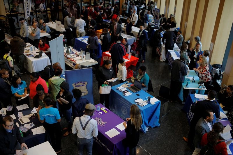 � Reuters. FILE PHOTO: Job seekers speak with potential employers at a City of Boston Neighborhood Career Fair on May Day in Boston, Massachusetts, U.S., May 1, 2017. REUTERS/Brian Snyder/File Photo