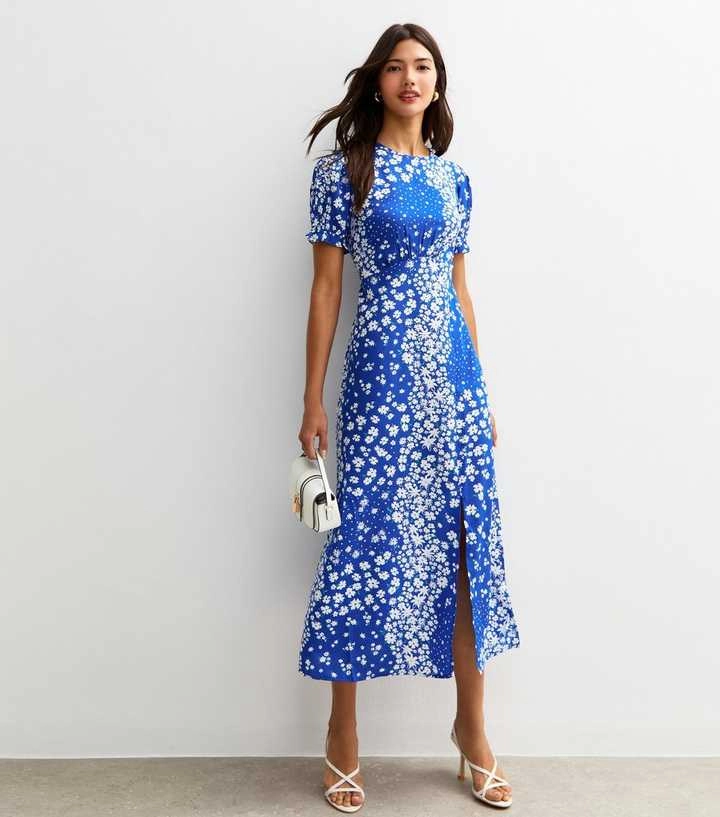 Woman in a blue floral midi dress.