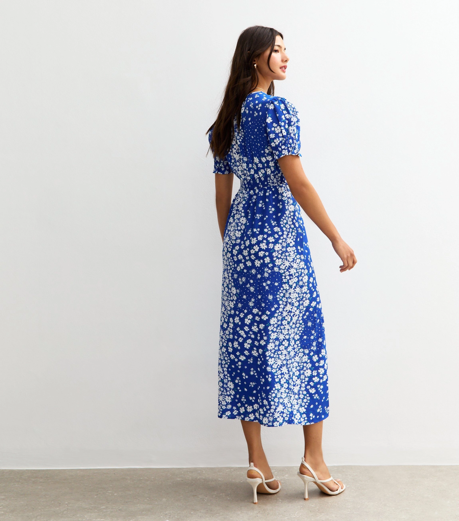Woman in a blue floral midi dress.