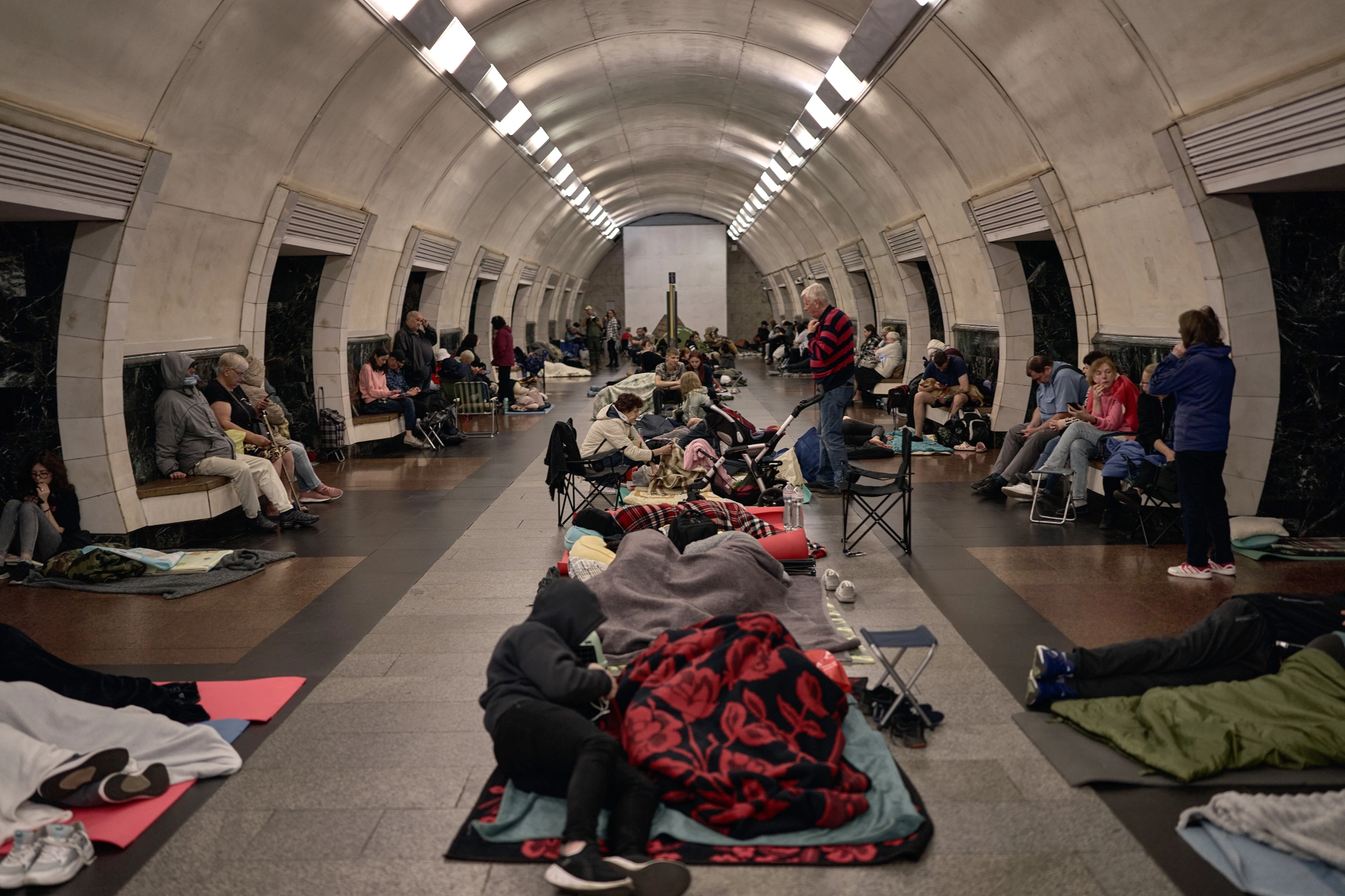 People sleeping on the floor of a Kyiv metro station during a missile attack.