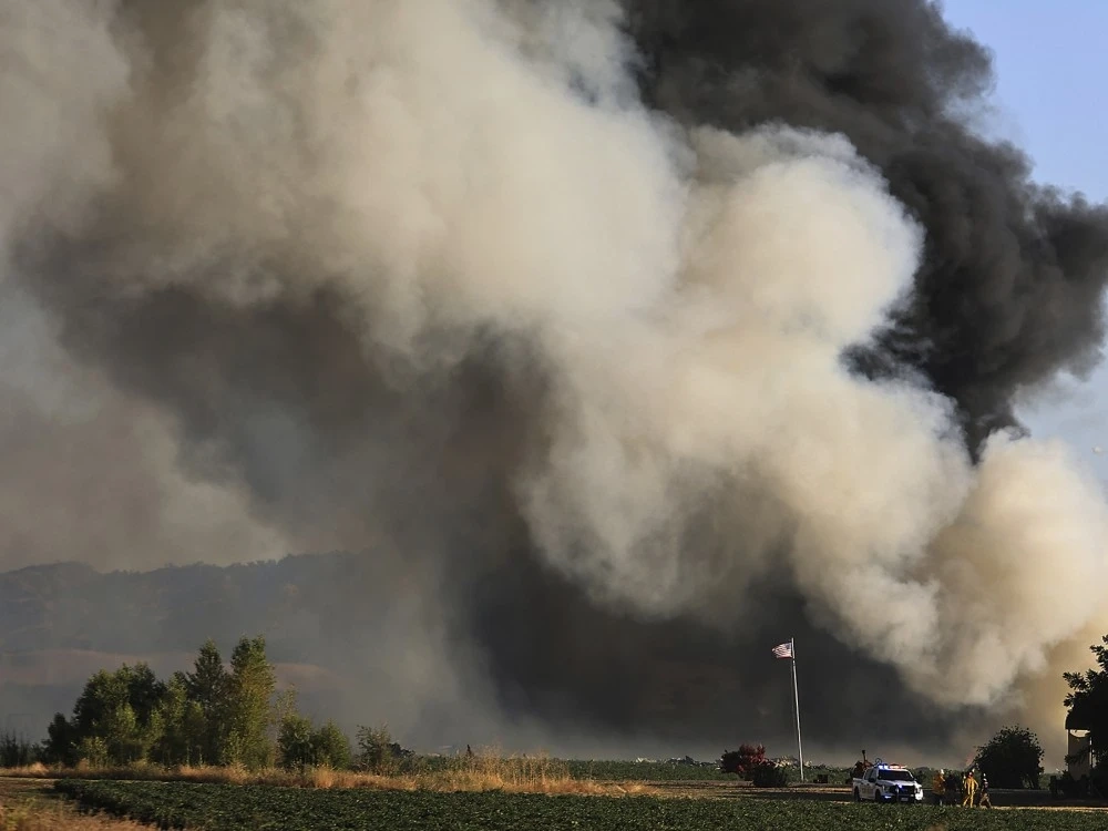 Smoke and flames rise during a fireworks warehouse explosion near Esparto, Calif., Tuesday, July 1, 2025.