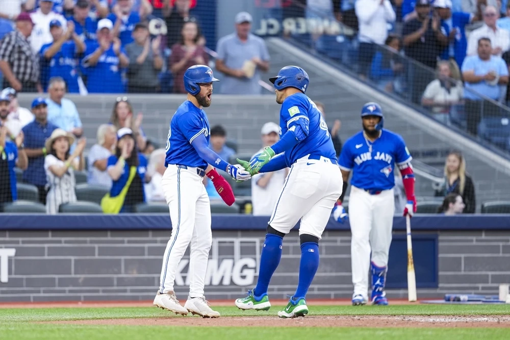Blue Jays' George Springer (right) celebrates his two-run home run against the New York Yankees with Nathan Lukes (left) during the third inning in Toronto on Thursday, July 3, 2025.