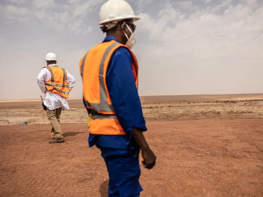 Mine workers walk on the residual dump at the Cominak mine near Arlit, Niger, March 8, 2023.