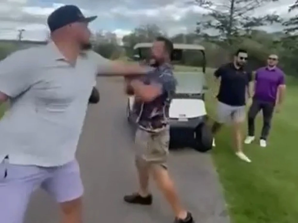 Two golfers square off during a fight on a course.