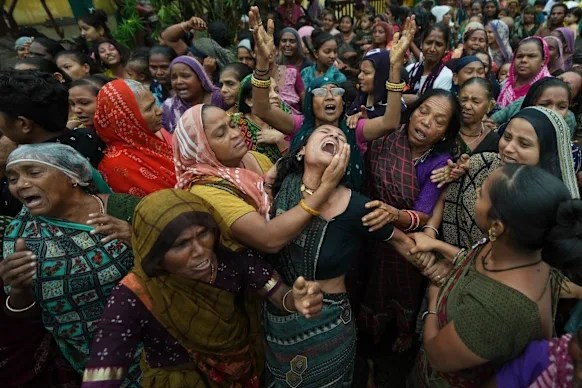Family members and relatives of Akash Patni, a victim of the Air India plane crash, grieve during his funeral procession in Ahmedabad last month.