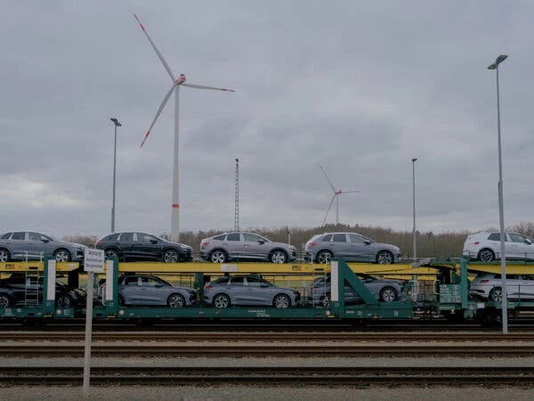 Cars on a train at a rail station.