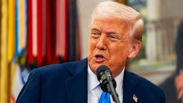 Donald Trump on blue tie, white shirt and black suit