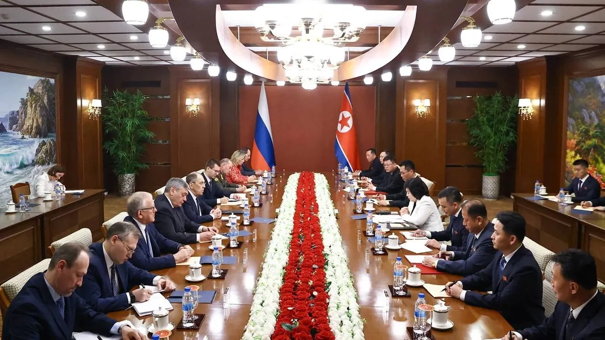 Sergei Levrov at a table with officals in North Korea