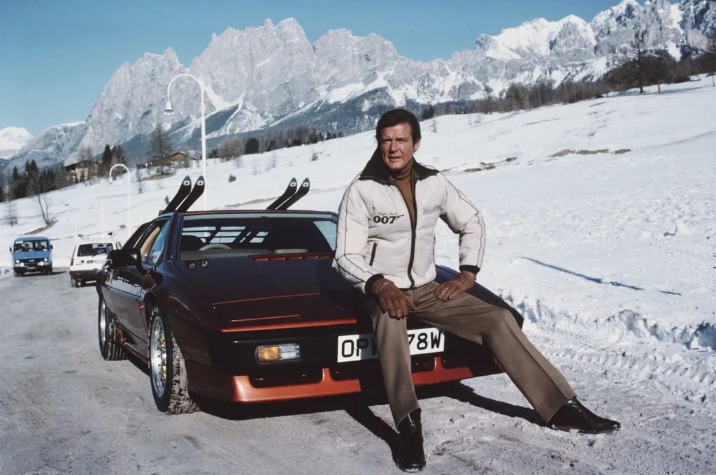 English actor Roger Moore poses as 007, with a Lotus Esprit Turbo, on the set of the James Bond film For Your Eyes Only in 1981