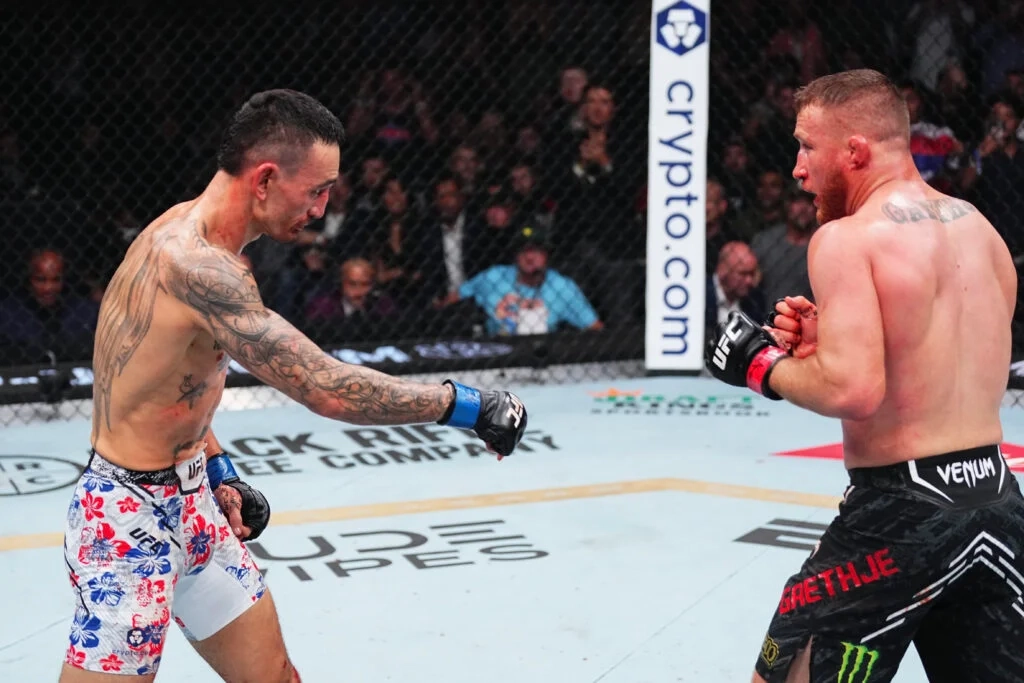 Max Holloway points to the ground in front of Justin Gaethje in the final seconds at UFC 300