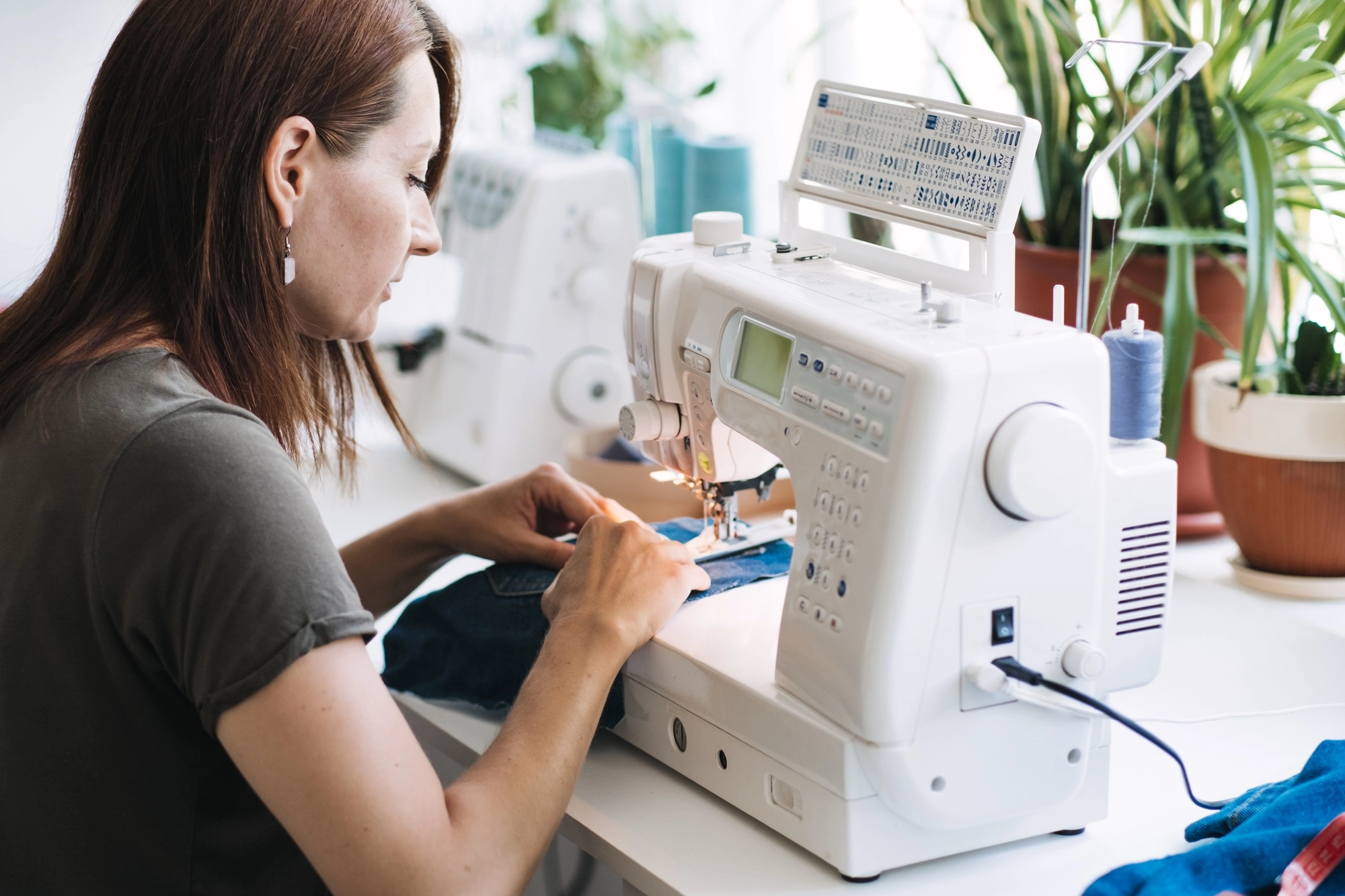 Reuse, repair, upcycle. Denim upcycling ideas, repair and using old jeans. Close-up of sewing